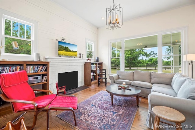 5606 Rocky Creek Rd, Ashford, AL 36312 - living area with hardwood / wood-style floors, a chandelier, and a brick fireplace
