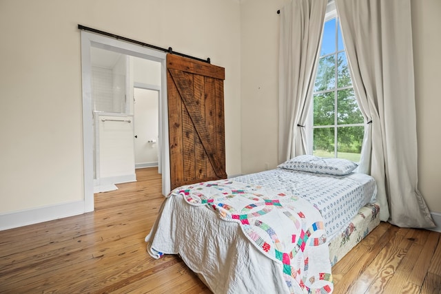 5606 Rocky Creek Rd, Ashford, AL 36312 - bedroom featuring wood finished floors and a barn door