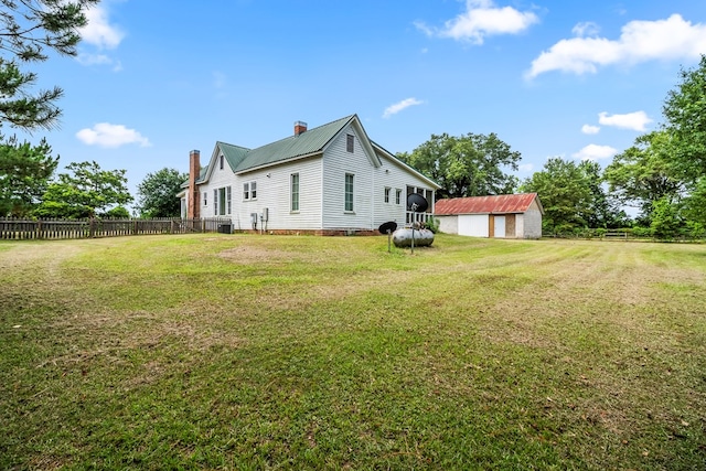 5606 Rocky Creek Rd, Ashford, AL 36312 - view of home's exterior with a chimney, a garage, a metal roof, and an outdoor structure