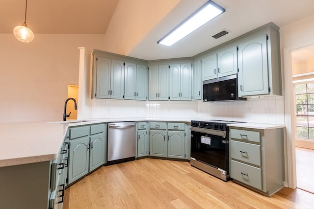 kitchen with visible vents, range with electric cooktop, dishwasher, black microwave, and a sink