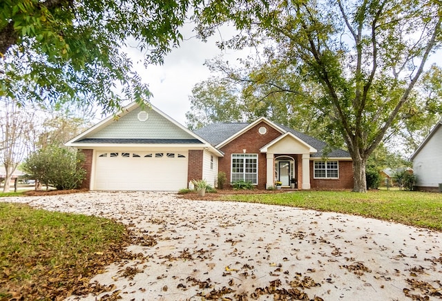 single story home with a garage, concrete driveway, brick siding, and a front yard