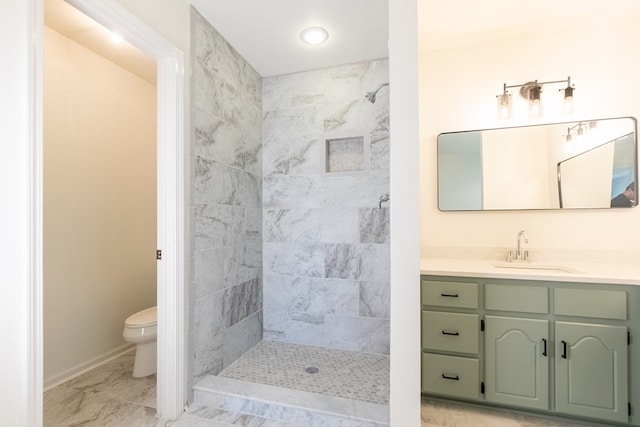 bathroom with baseboards, tiled shower, toilet, marble finish floor, and vanity