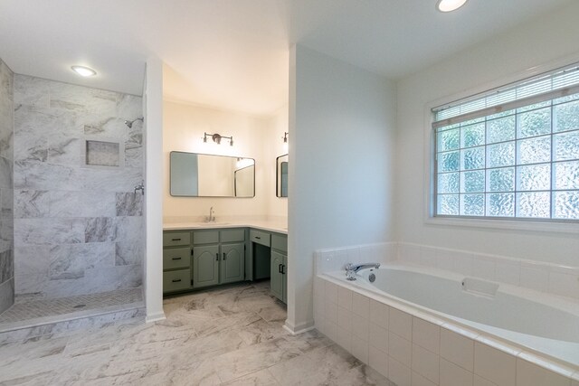 full bathroom featuring marble finish floor, vanity, a bath, and a walk in shower