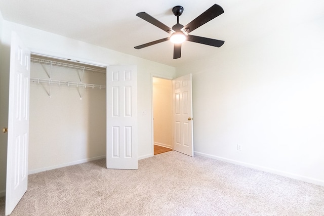 unfurnished bedroom featuring a ceiling fan, a closet, carpet flooring, and baseboards