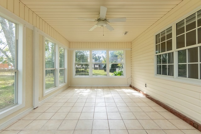 unfurnished sunroom featuring ceiling fan