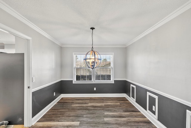 unfurnished dining area with dark wood-style floors, a chandelier, a textured ceiling, and baseboards