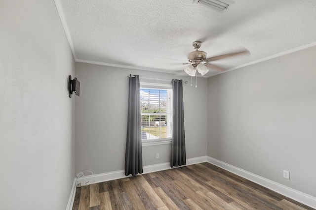 unfurnished room featuring visible vents, ornamental molding, a ceiling fan, dark wood finished floors, and baseboards