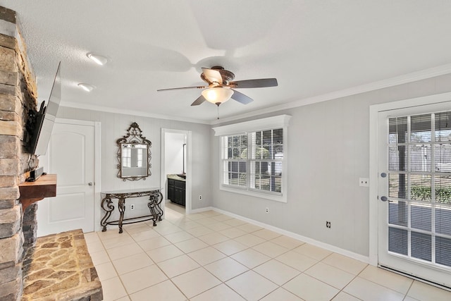 interior space with light tile patterned floors, a textured ceiling, ceiling fan, and crown molding