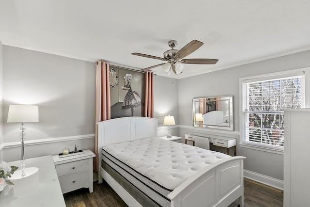 bedroom featuring baseboards, a ceiling fan, dark wood finished floors, and crown molding