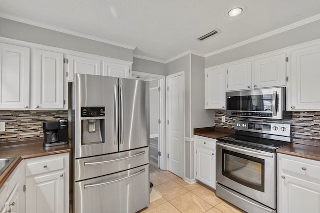 kitchen featuring dark countertops, visible vents, white cabinets, and stainless steel appliances