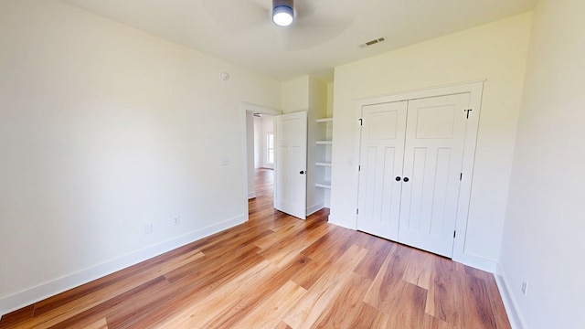 108 Weeping Willow Trl, Headland, AL 36345 - unfurnished bedroom with light wood-type flooring, a closet, baseboards, and a ceiling fan