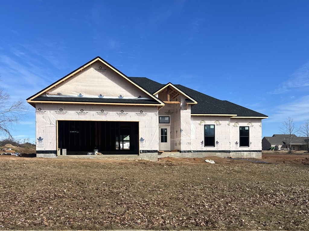 unfinished property featuring a garage