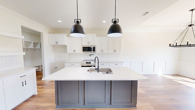 108 Weeping Willow Trl, Headland, AL 36345 - kitchen with stainless steel appliances, a sink, crown molding, decorative backsplash, and light countertops