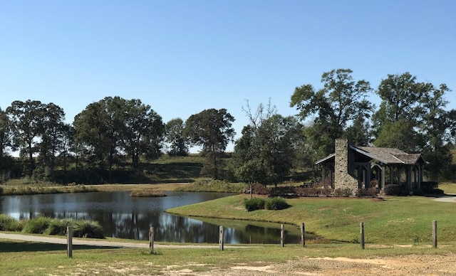 view of property's community featuring a water view and a yard