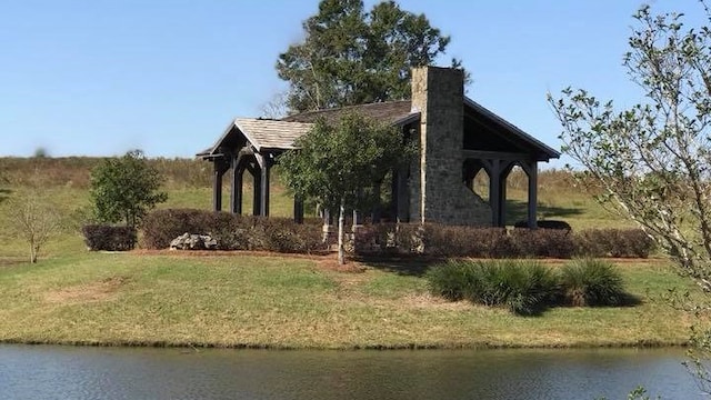 108 Weeping Willow Trl, Headland, AL 36345 - view of side of property with a water view, a chimney, and a lawn