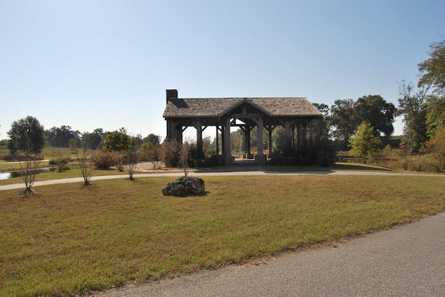 surrounding community with a gazebo and a lawn