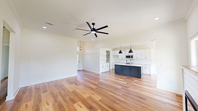 108 Weeping Willow Trl, Headland, AL 36345 - unfurnished living room featuring a sink, a ceiling fan, light wood finished floors, ornamental molding, and recessed lighting