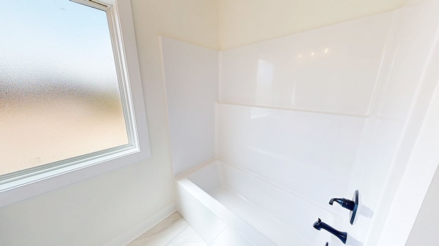 108 Weeping Willow Trl, Headland, AL 36345 - bathroom with baseboards, marble look tile flooring, and washtub / shower combination