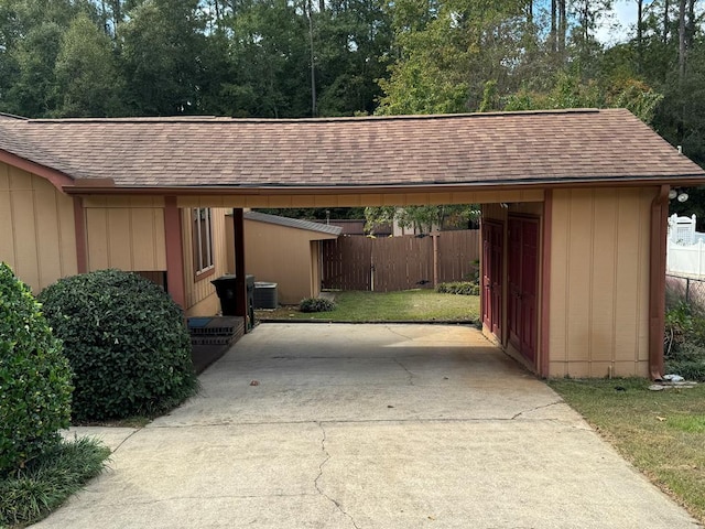 view of parking featuring a lawn and a carport