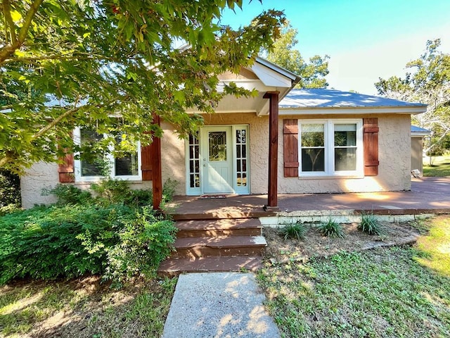 back of property featuring covered porch