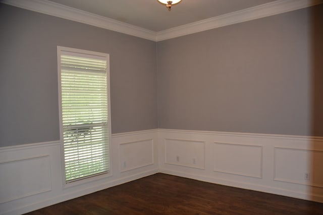 unfurnished room featuring a decorative wall, dark wood-style flooring, a wainscoted wall, and ornamental molding