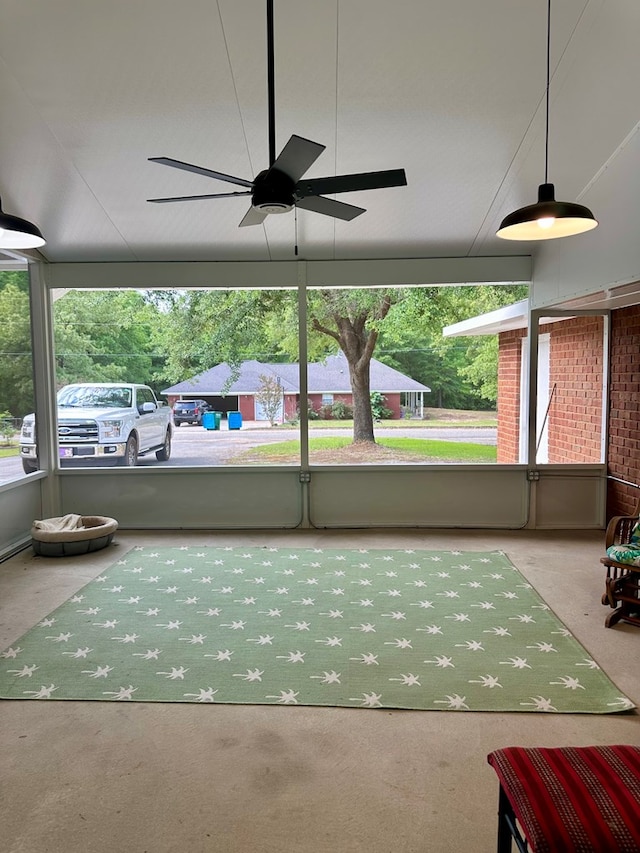 sunroom featuring a ceiling fan