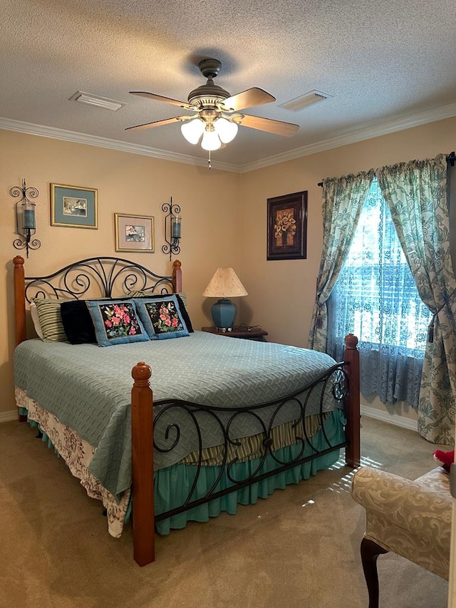 carpeted bedroom with crown molding, a textured ceiling, and visible vents