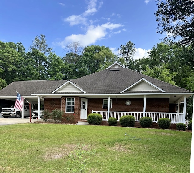 view of front of property with a porch, an attached carport, and a front lawn