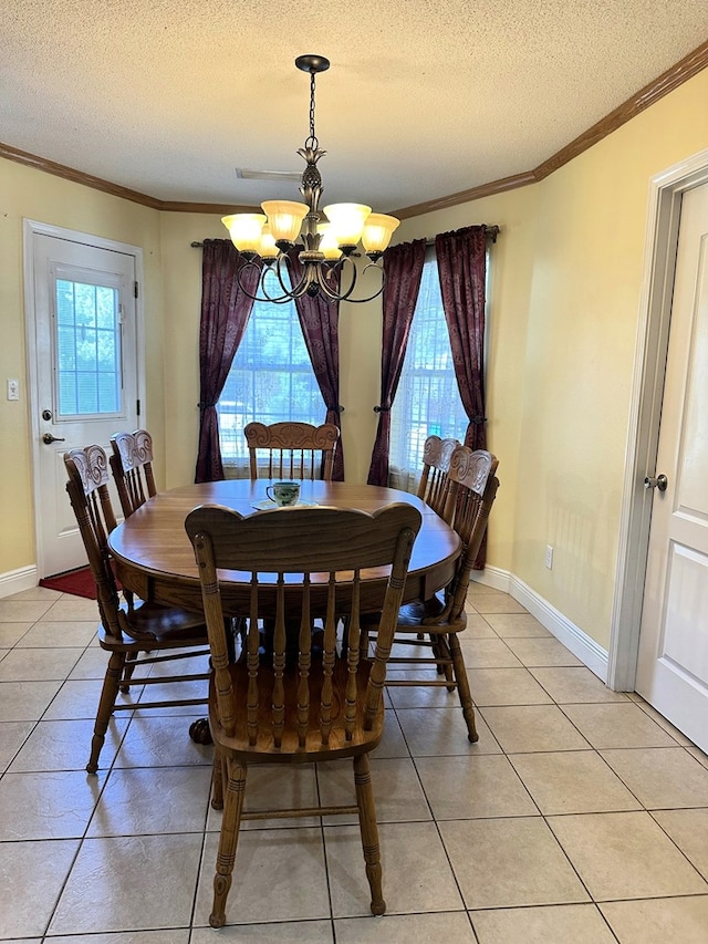 dining area with crown molding, a textured ceiling, and an inviting chandelier