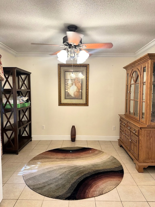 interior space with crown molding, light tile patterned flooring, a ceiling fan, and a textured ceiling
