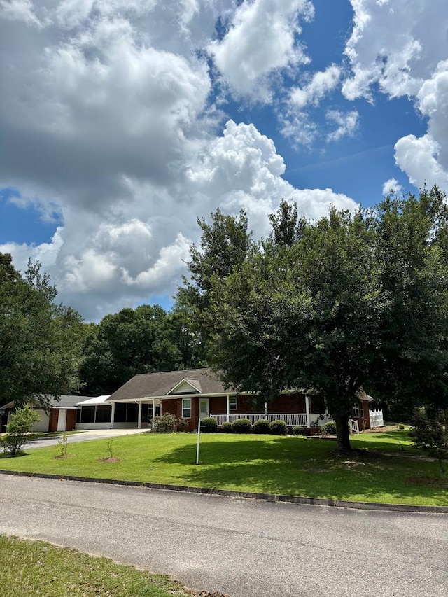 252 Red Maple Dr, Flomaton, AL 36441 - view of front of home featuring driveway and a front yard