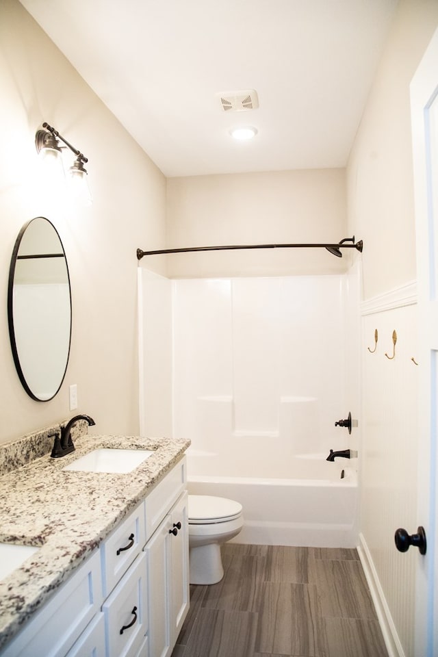 full bathroom with washtub / shower combination, vanity, and toilet