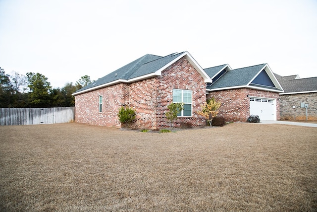 view of property exterior featuring a yard and a garage