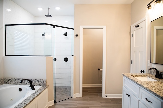 bathroom with vanity and shower with separate bathtub