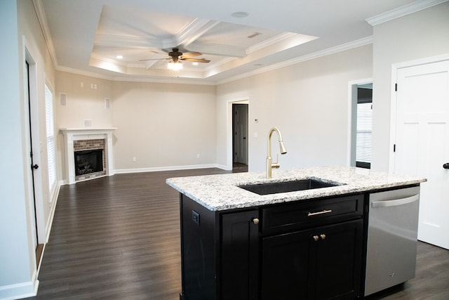 kitchen with ornamental molding, sink, stainless steel dishwasher, and a kitchen island with sink