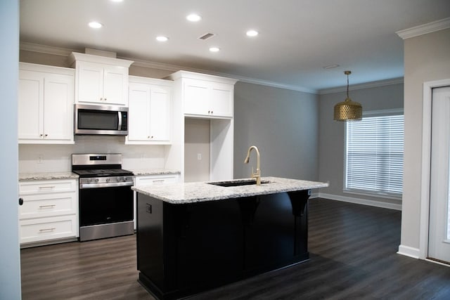 kitchen featuring sink, stainless steel appliances, light stone countertops, white cabinets, and a center island with sink