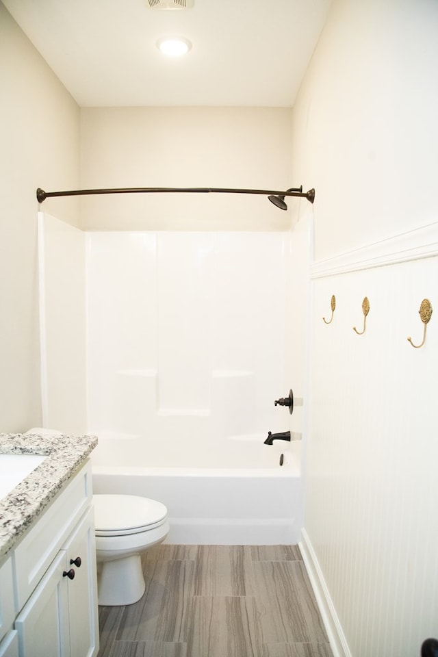 full bathroom with vanity, washtub / shower combination, and toilet