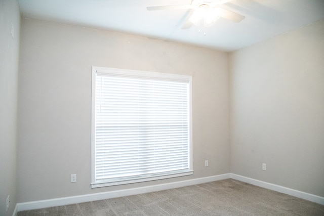 unfurnished room with ceiling fan and light carpet