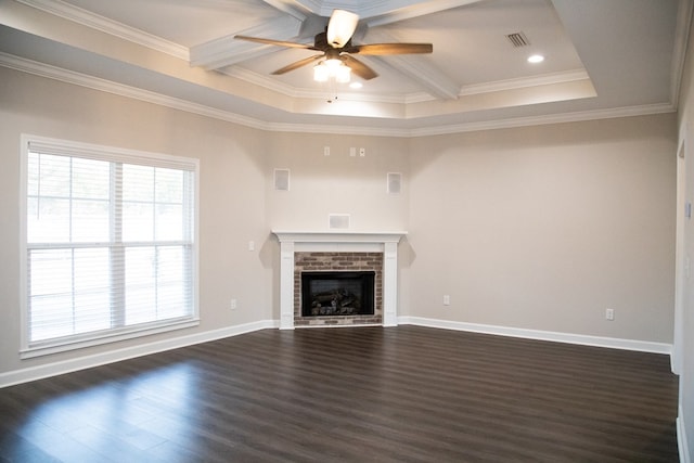 unfurnished living room featuring ceiling fan, a fireplace, ornamental molding, dark hardwood / wood-style flooring, and beamed ceiling