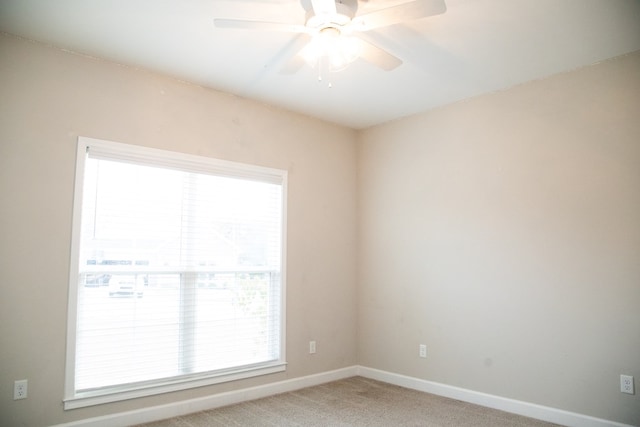 carpeted empty room featuring ceiling fan