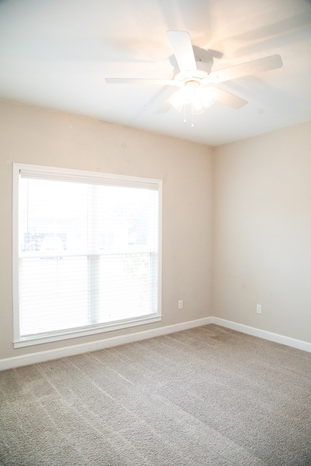 carpeted empty room with ceiling fan