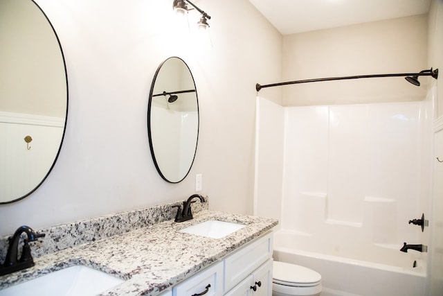 full bathroom with vanity, tub / shower combination, and toilet