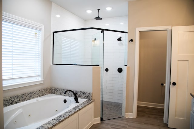 bathroom featuring plus walk in shower and a wealth of natural light