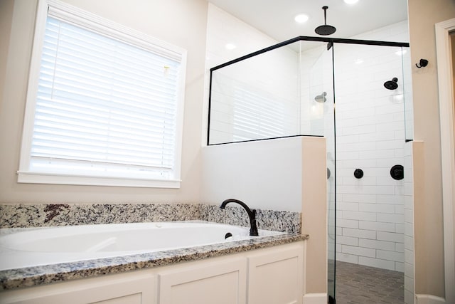 bathroom featuring shower with separate bathtub