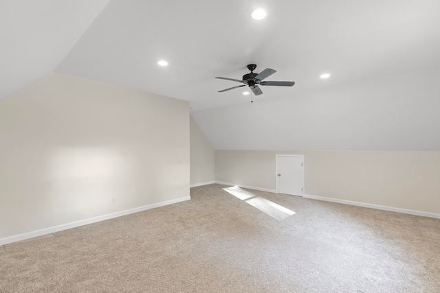 bonus room with ceiling fan, light colored carpet, and vaulted ceiling