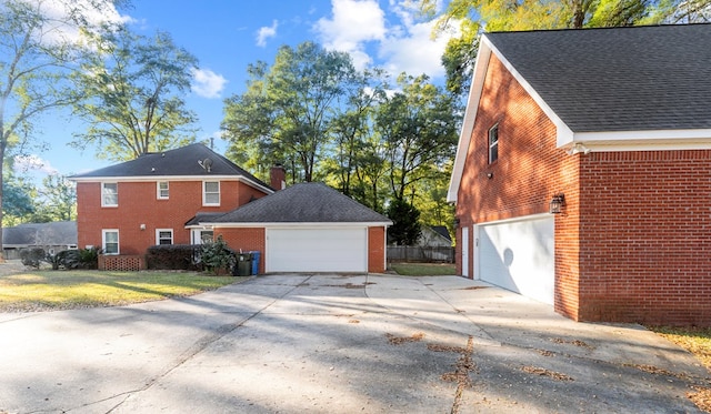 view of side of property featuring a yard and a garage