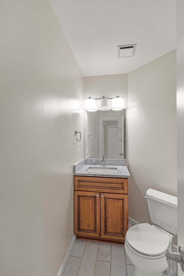 bathroom with tile patterned floors, vanity, and toilet