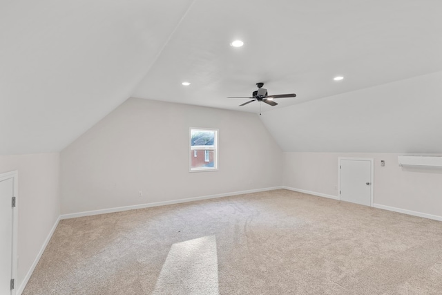 additional living space with ceiling fan, light carpet, and lofted ceiling