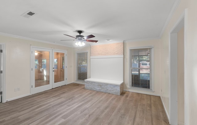 interior space featuring ceiling fan, ornamental molding, light hardwood / wood-style flooring, and french doors