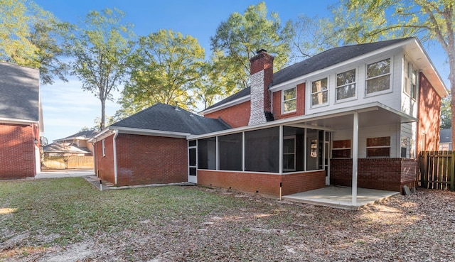 rear view of property featuring a yard and a patio